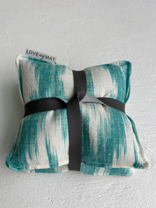 Abstract knee pillow with a black ribbon on a gray background