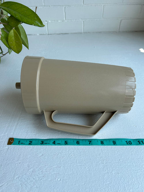 Beige Tupperware jug with a measuring tape for scale