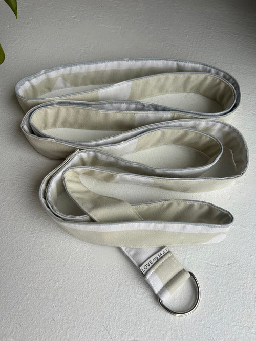 Set of three fabric straps on a light gray surface