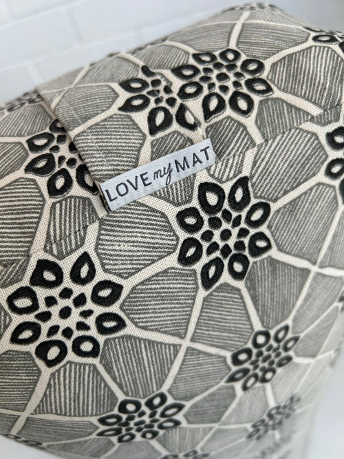 black floral patterned yoga bolster with a a 'LOVE MY MAT' label on a white background