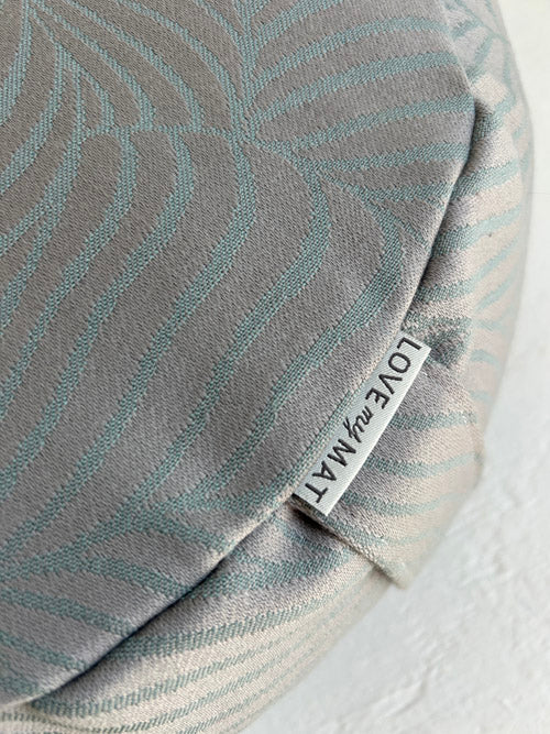 Gray textured fabric meditation cushion close up picture with a 'LOVE MY MATT' label on a white background