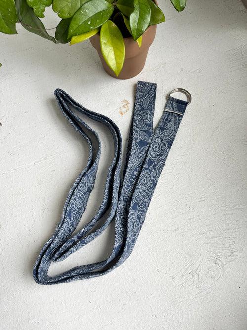 Blue paisley strap for yoga.