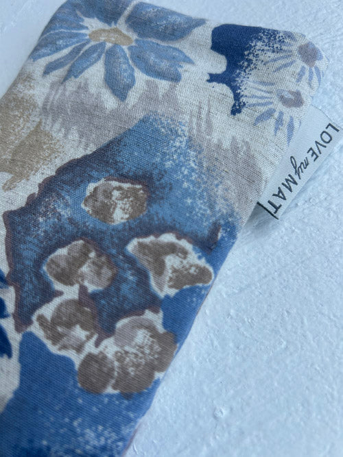 Fabric swatch with blue and gray floral pattern on a white background