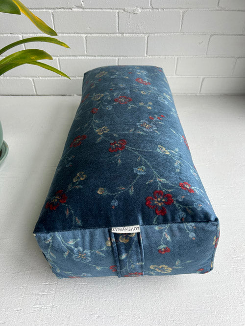 Blue Velour type fabric yoga bolster on white background