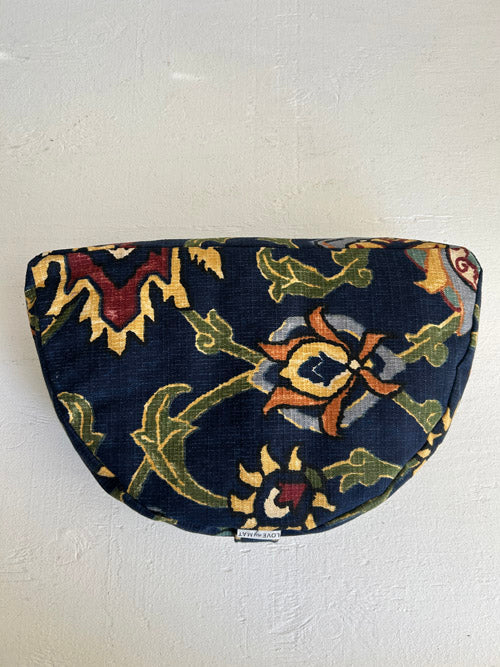 Top view of a meditation floor cushion in a colourful and high contrast fabric on a white surface.