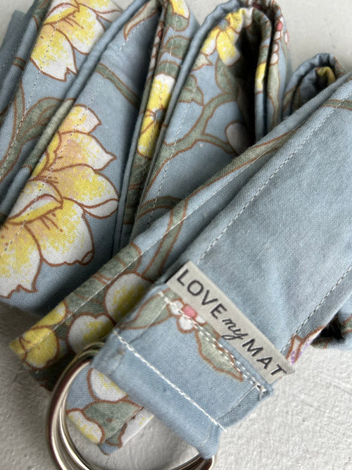 Close up of Blue background and floral patterned yoga strap