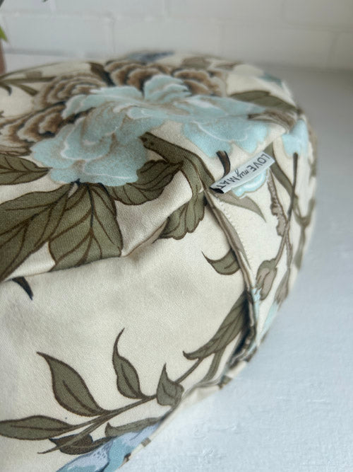 Floral-patterned fabric roll with 'Navy Blue' label on a white background