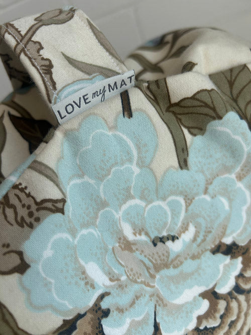 Floral-patterned product with 'LOVE my MAT' tag on a white background