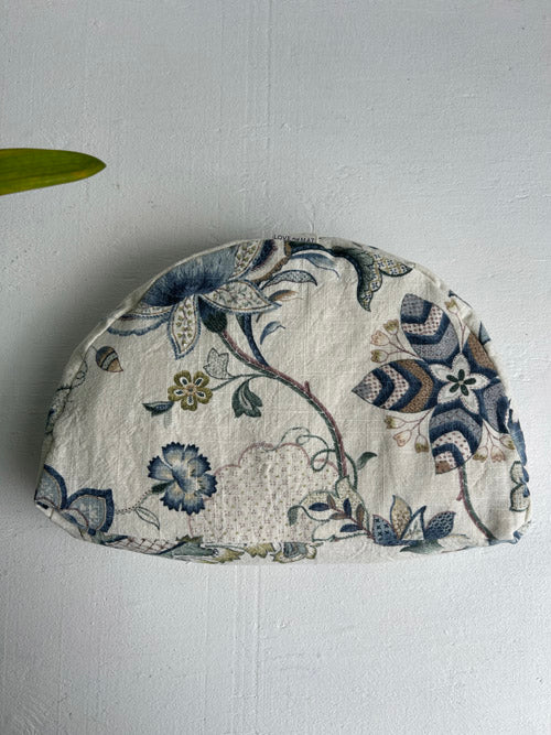 Floral-patterned fabric-covered meditation cushion on a white background