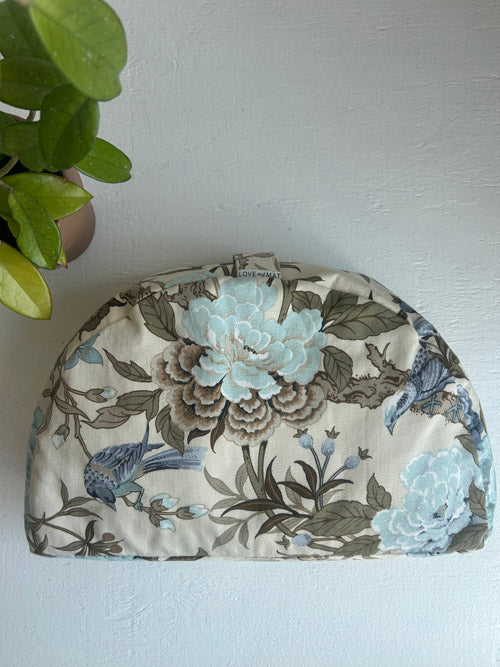 Floral and bird patterned fabric on a white background