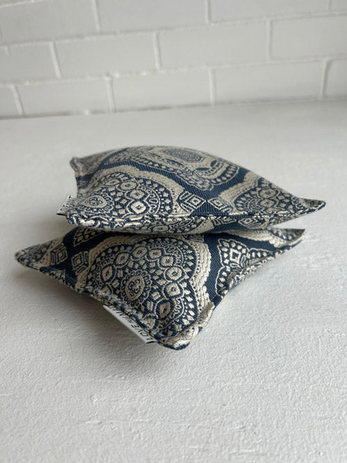 two knee pillows for yoga on a white background