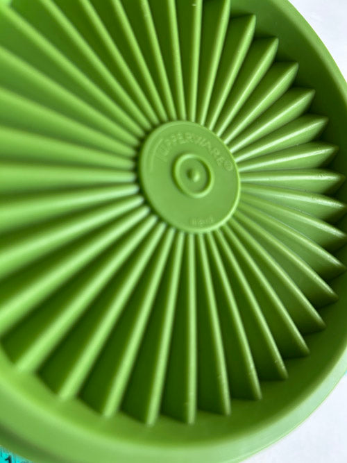 Green silicone lid with radial design on a white background