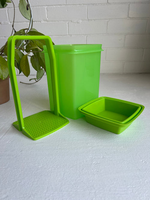 Green plastic containers with a stand on a white surface