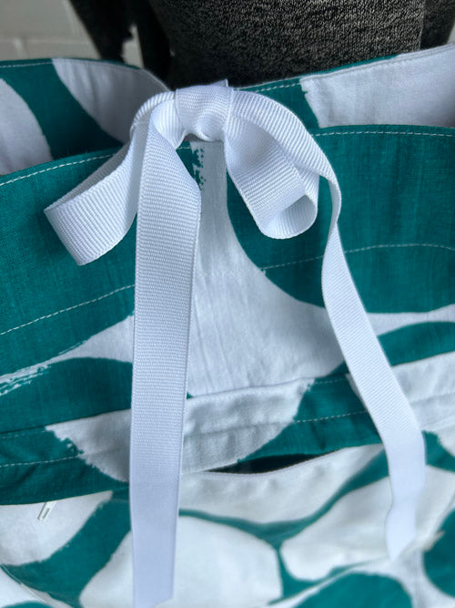 Green and white striped bag with a white strap