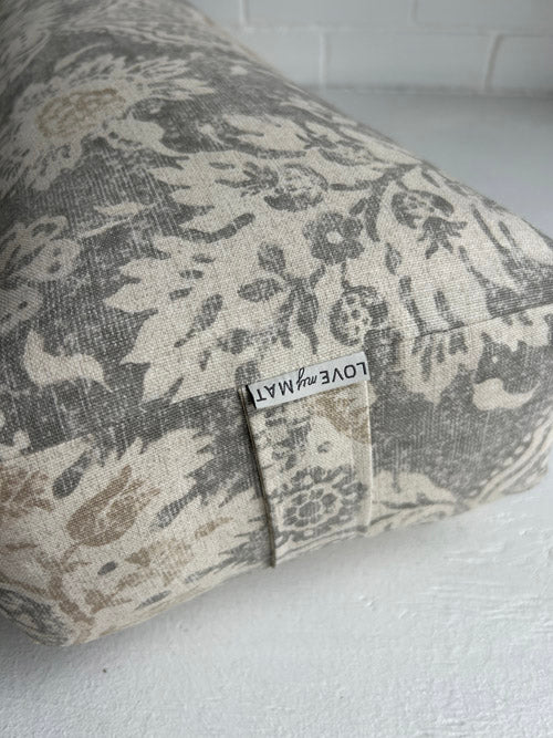Fabric yoga bolster with a floral pattern and 'LOVE my MAT' label on a white background