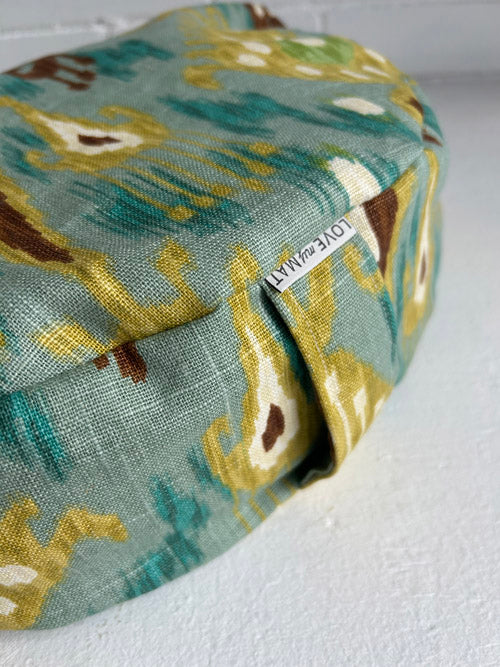 Fabric meditation cushion in an Ikat pattern on a white background