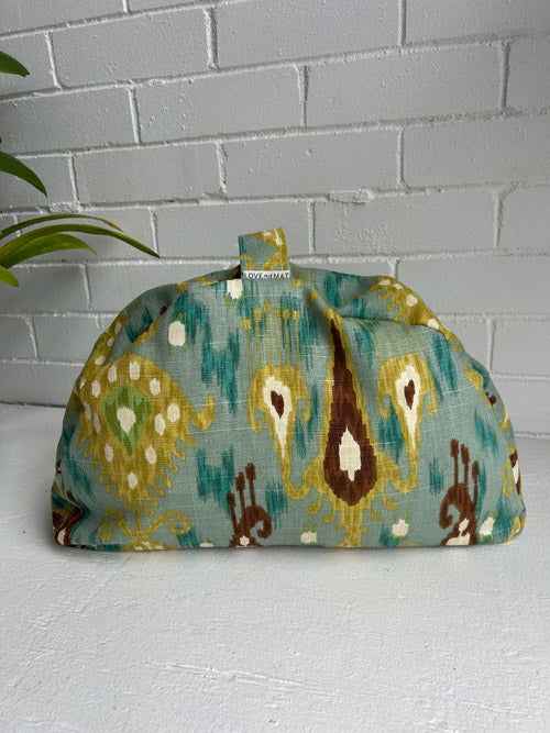 Meditation cuhsion with pattern on a white surface and white brick wall background