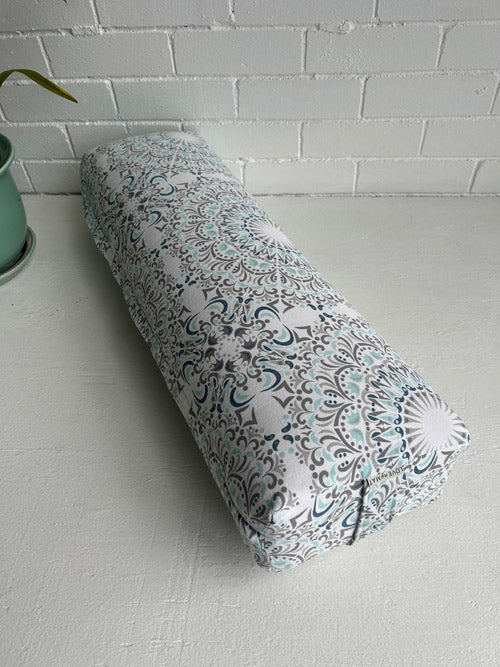 Long Yoga Bolster with black patterns on a white surface