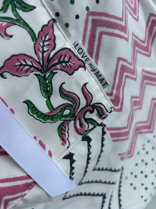 Close-up of a fabric with floral design and 'LOVE my MAT' label.