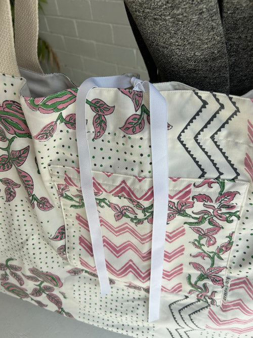 Patterned tote bag with colorful designs on a neutral background