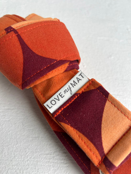 Fabric yoga strap with geometric pattern and 'LOVE my MATE' tag on a white background