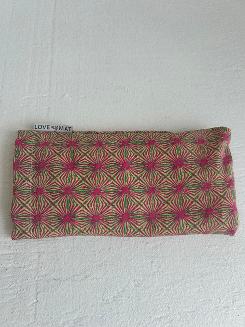 Fabric eye pillow with geometric pattern on a white background