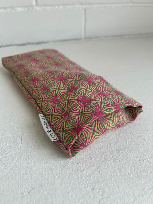 Fabric patterned eye pillow with a geometric pattern on a white surface