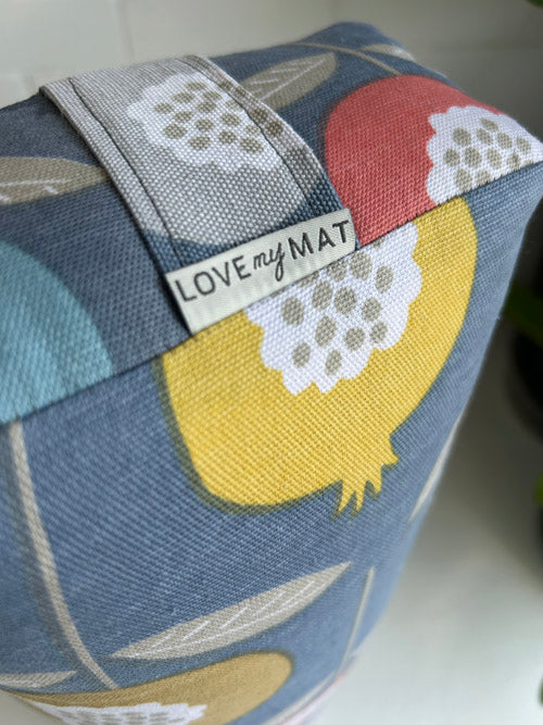 Fabric with colorful leaf patterns and 'LOVE my MAT' label on a blue background