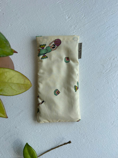 Eye pillow with embroidered designs on a light background