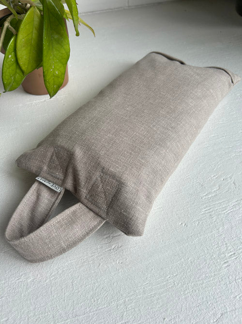Taupe Sandbag laying on a white surface