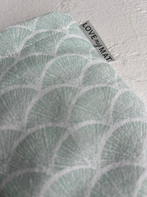 Textile with leaf pattern and 'LOVE my MAT' label on a white background