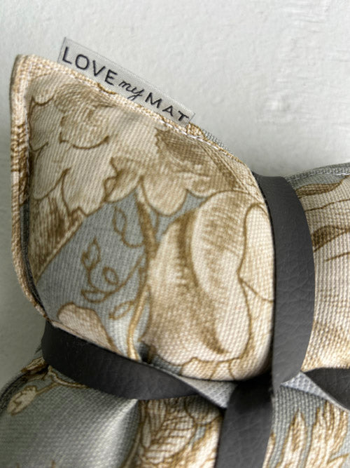 Fabric knee pilllows with floral pattern and 'LOVE my MAT' label on a textured background