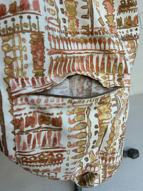 Patterned fabric  yoga mat bag with brown and gold design on a white background